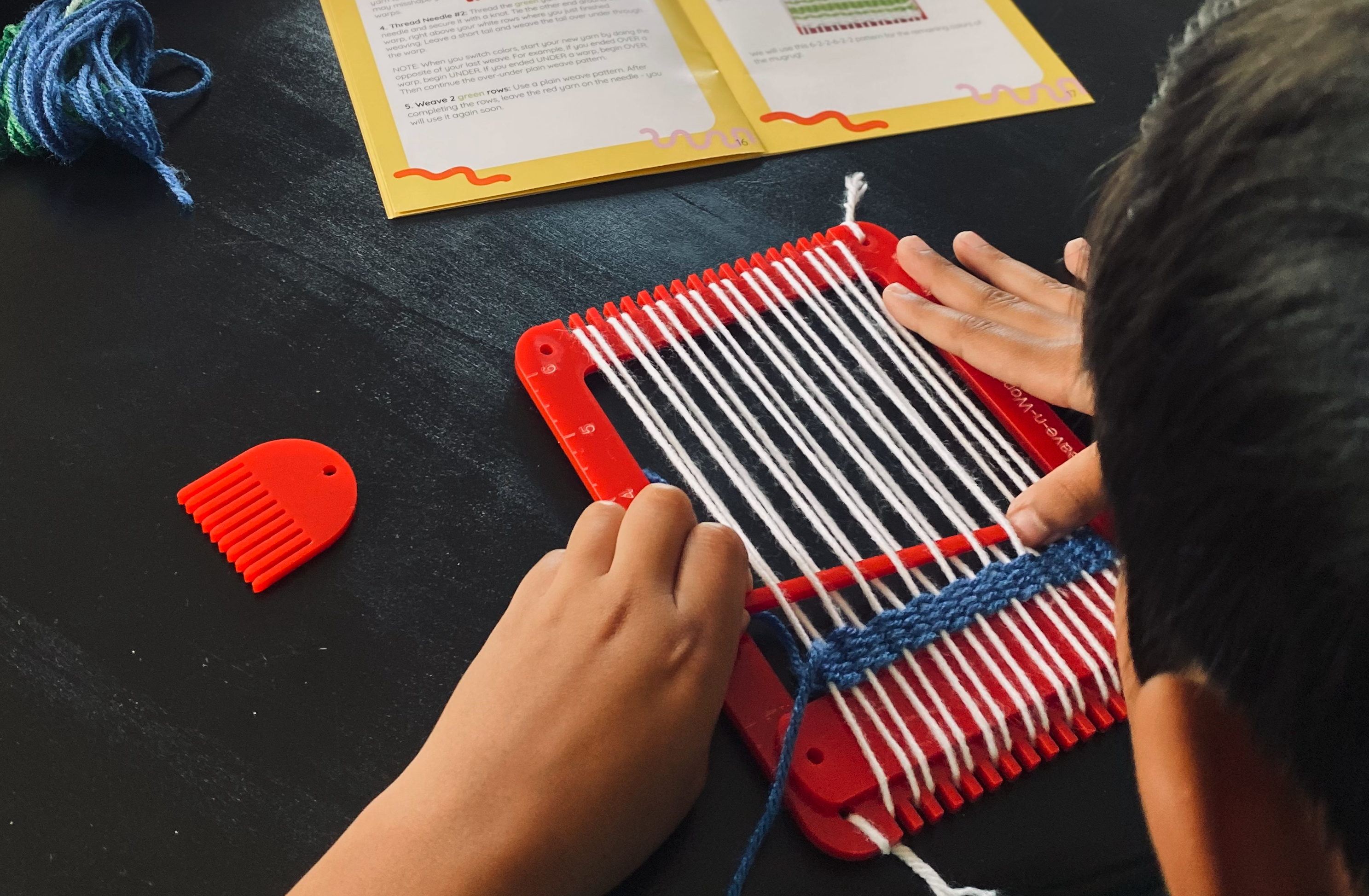 Child weaving with Weave-n-Wonder kit